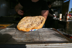 Grilled dessert on a metal rack at an outdoor grill station.