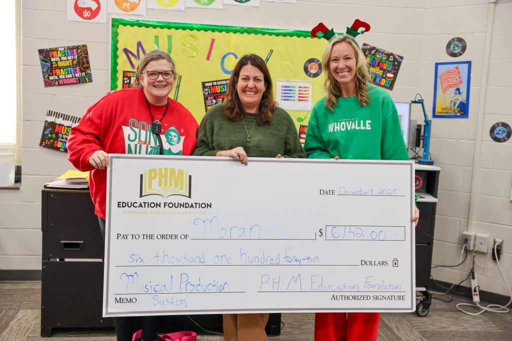 People holding big check