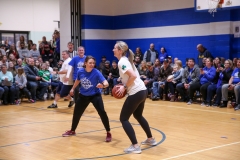 People playing basketball on a court.