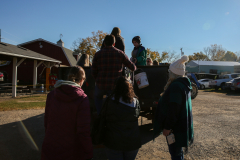 People standing around a small stage at an outdoor event.