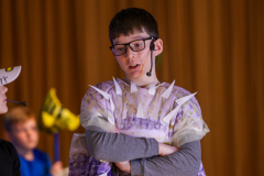 A person in a costume standing on stage.