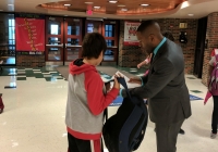 Grissom Principal Jean Milfort helps students on the 1st Day of School