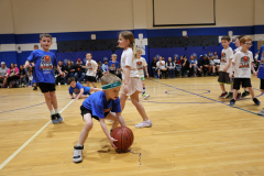 First graders playing in their March Madness basketball game