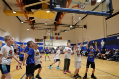 Second graders playing in their March Madness basketball game