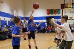First graders playing in their March Madness basketball game