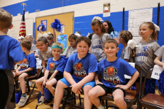 Student players "Blue Team" taking a break on the sidelines 