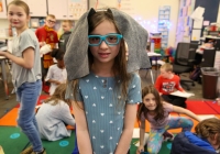 Young girl in a classroom setting wearing an elephant costume.