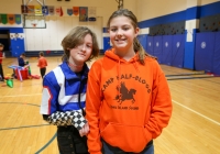 Two people posing in a gymnasium.