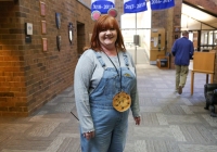 Woman wearing a cookie costume in an indoor setting.